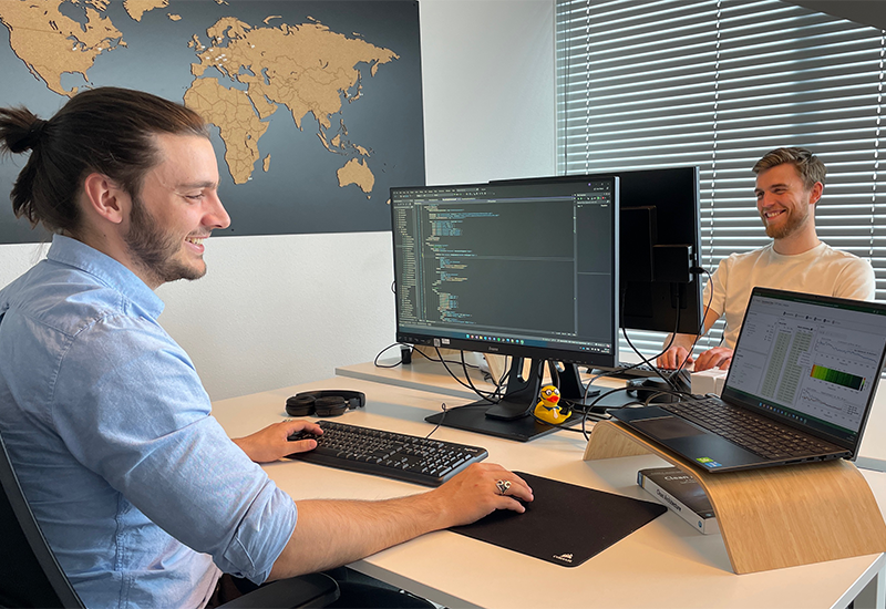 Software Developers Stathis (left) and Jelle (right) coding C#